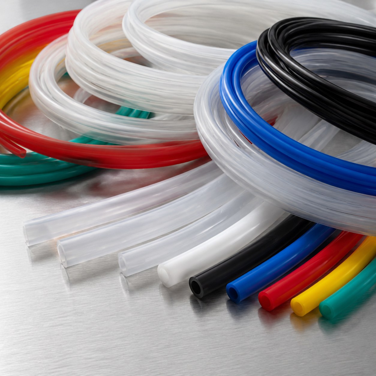 Photorealistic industrial website image for custom fluoropolymer tubing: material and color options for PTFE FEP PFA tubing, no text, no logo, no watermark